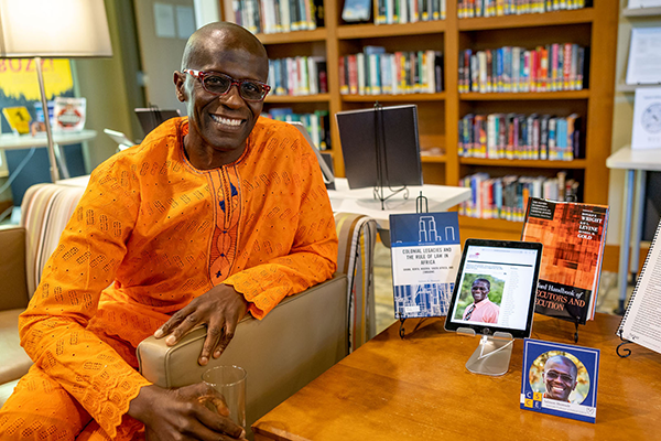 Salmon Shomade poses with his published research.