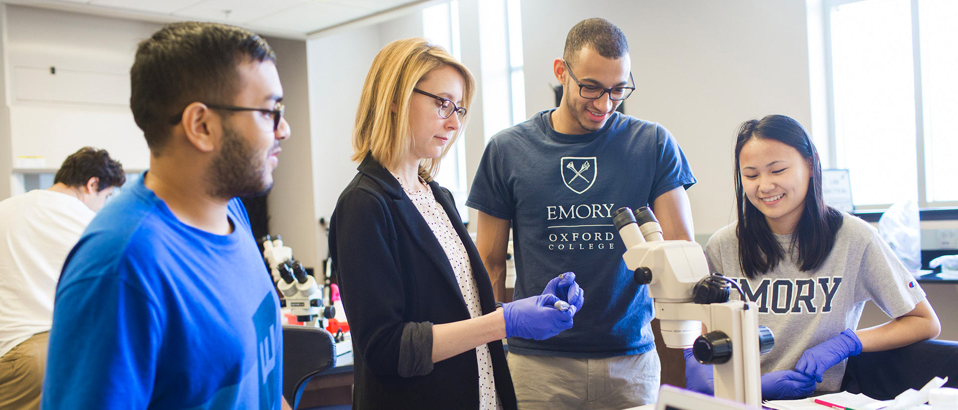 Sarak Fankhauser works with students in the biology lab.