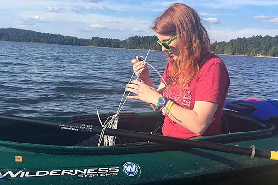 Camilla Kline takes water samples from reservoirs near the campus.