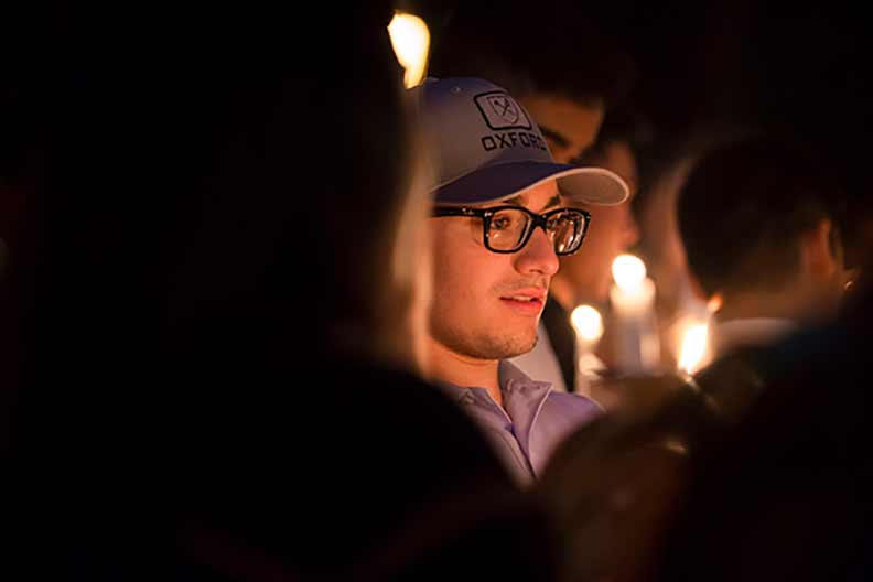 A student takes part in the candelight procession as part of Convocation.