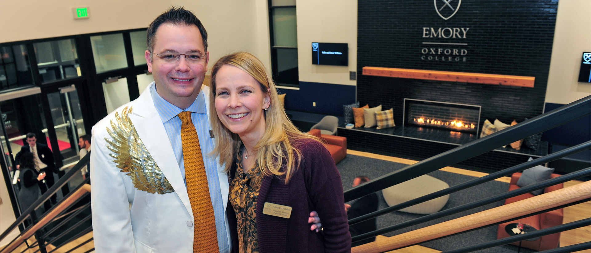 Chris and Amanda Arrendale on staircase in front of fireplace in Oxford Student Center