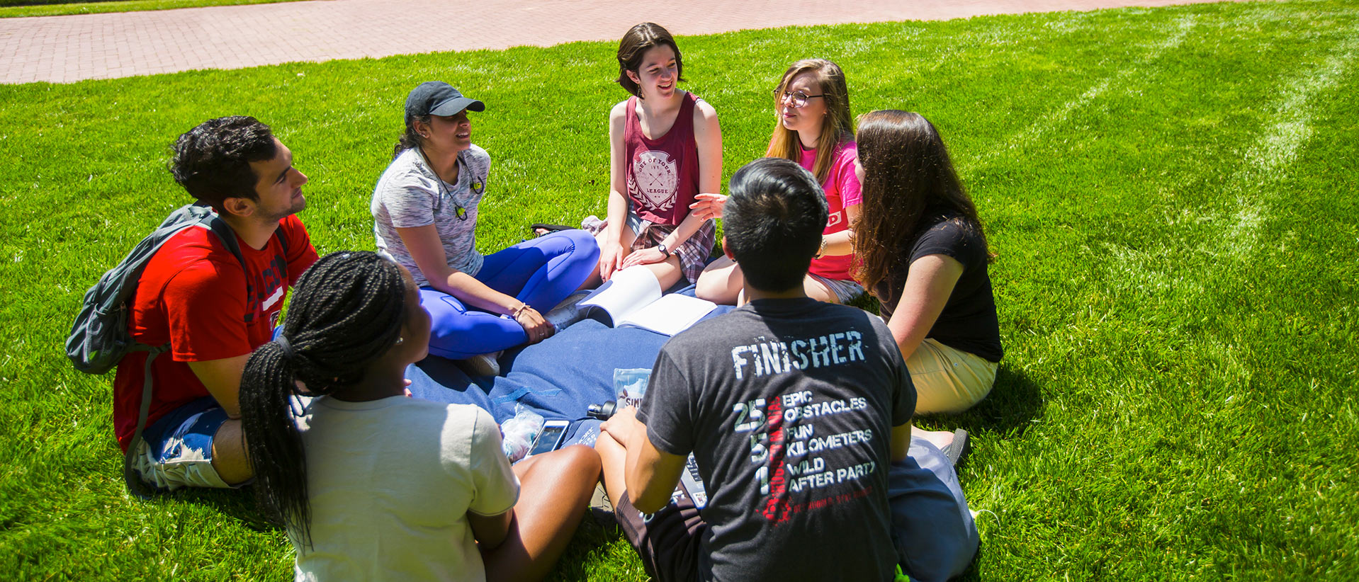 Students sit on the quad outside the Oxford library.