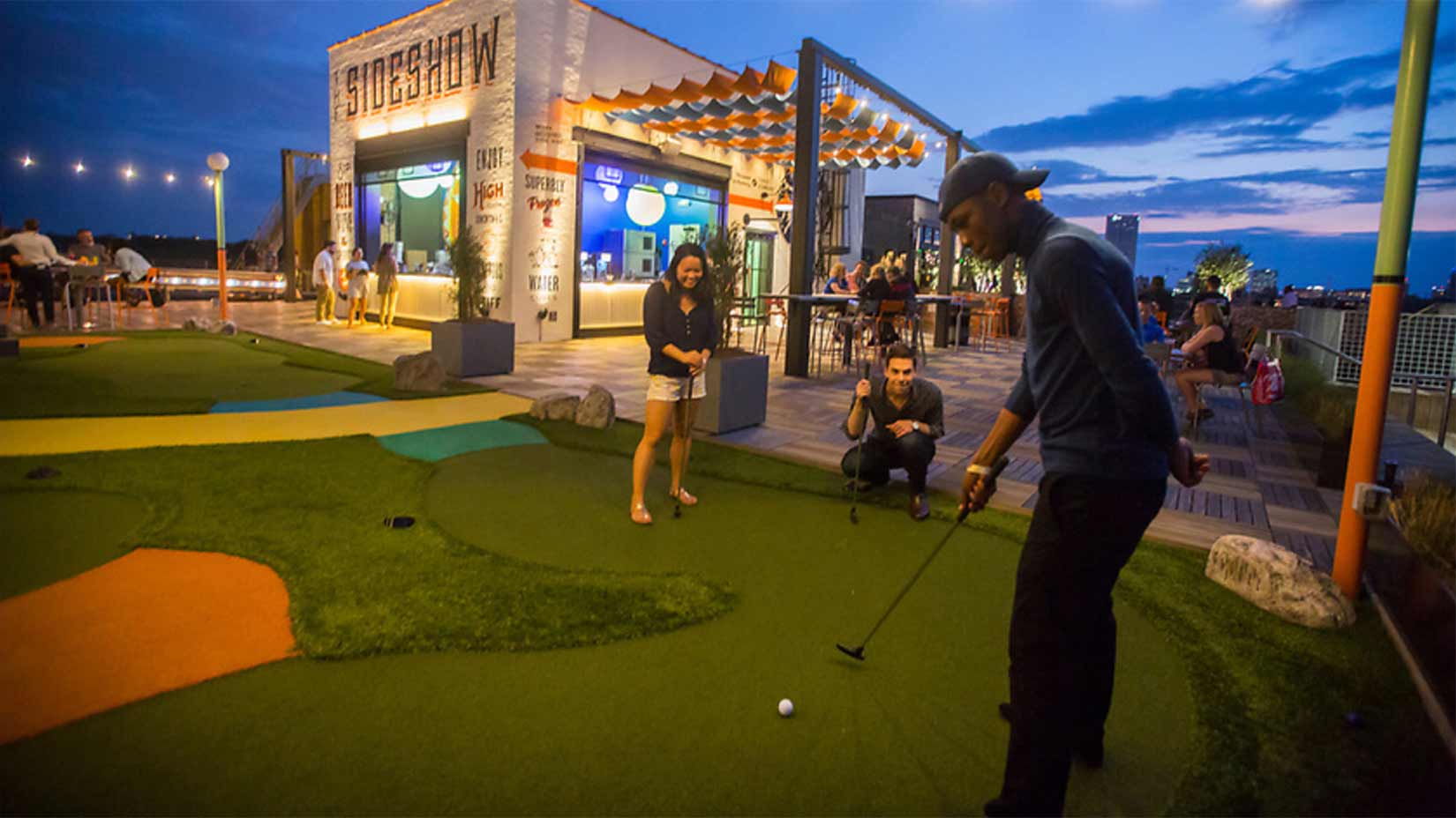 Students play minigolf on the rooftop of Ponce City Market.