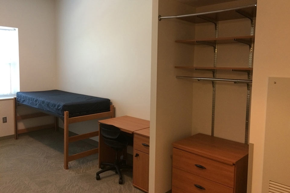 View of a Desk, Bed, and Closet in room