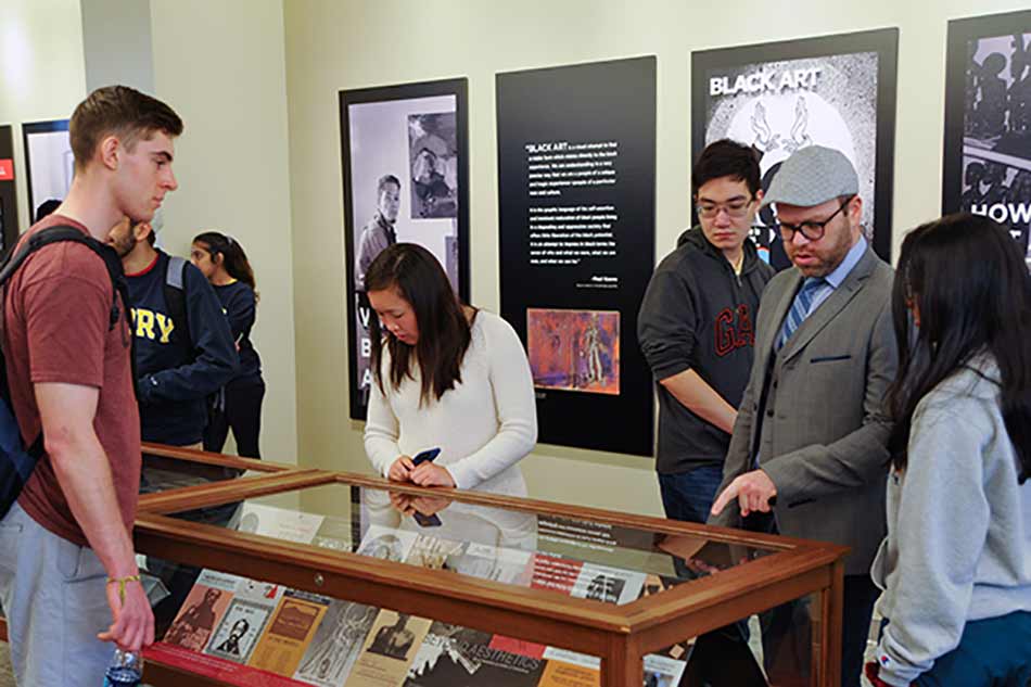 A class explores an exhibit at the Oxford library.