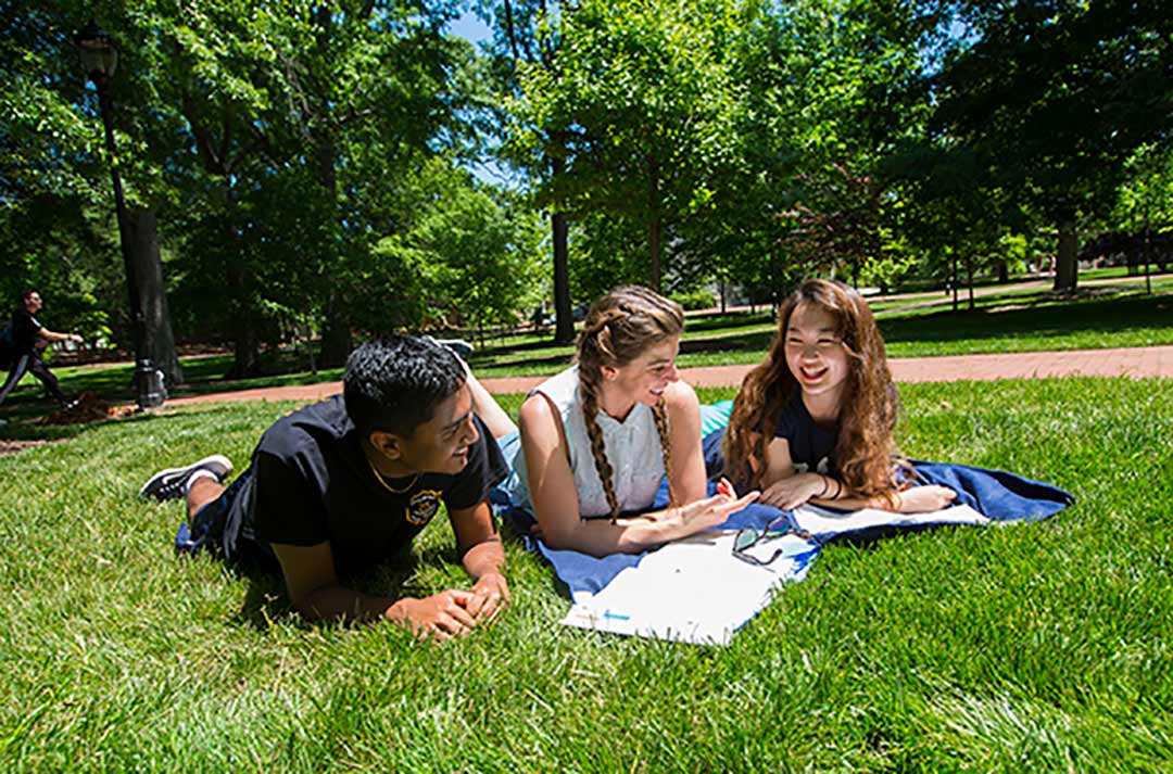 Students walk along Oxford's paved walkways past Candler Hall.