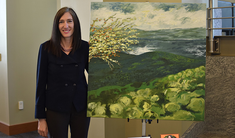 Catherine Chastain-Elliott, senior associate dean of academic affairs, with My Father Sees, her original oil painting.