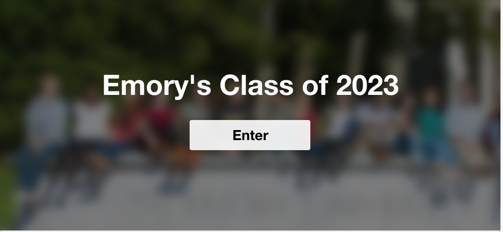 Students sit on the Emory University entrance sign.