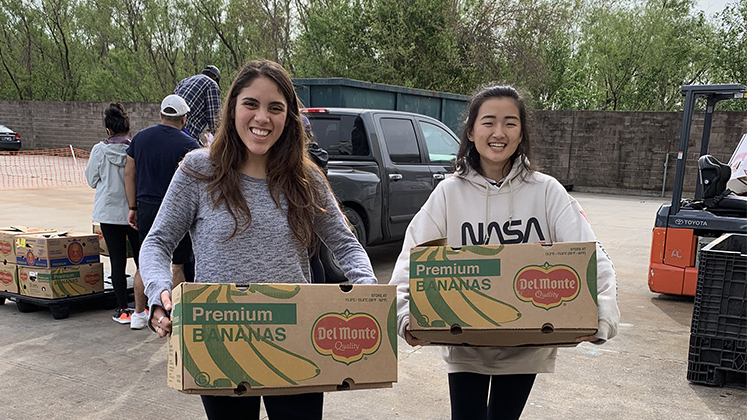 Oxford students help unload boxes of food at a New Orleans food pantry.