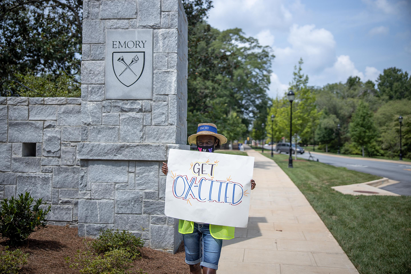 Student holding welcome sign at Oxford entrance