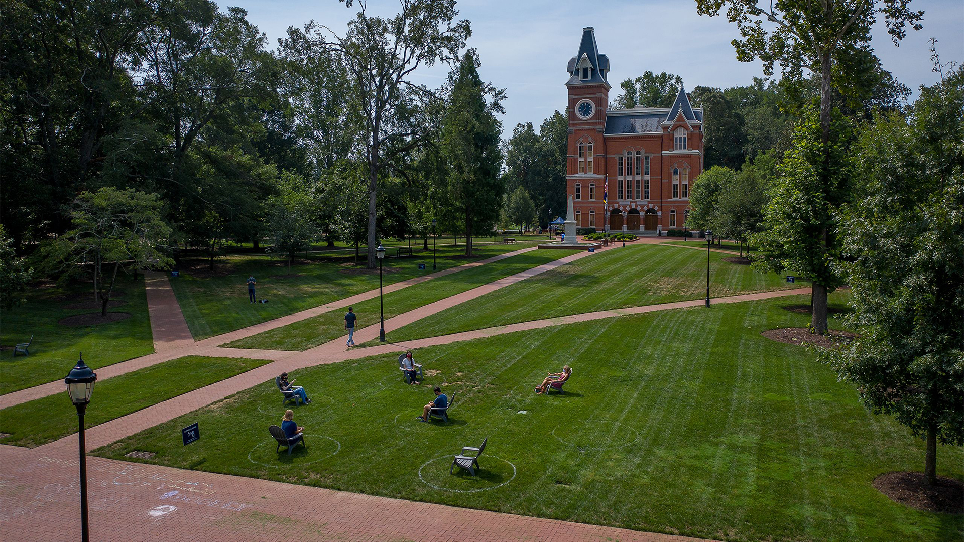 Students sit in Adirondack chairs on the Oxford quad.