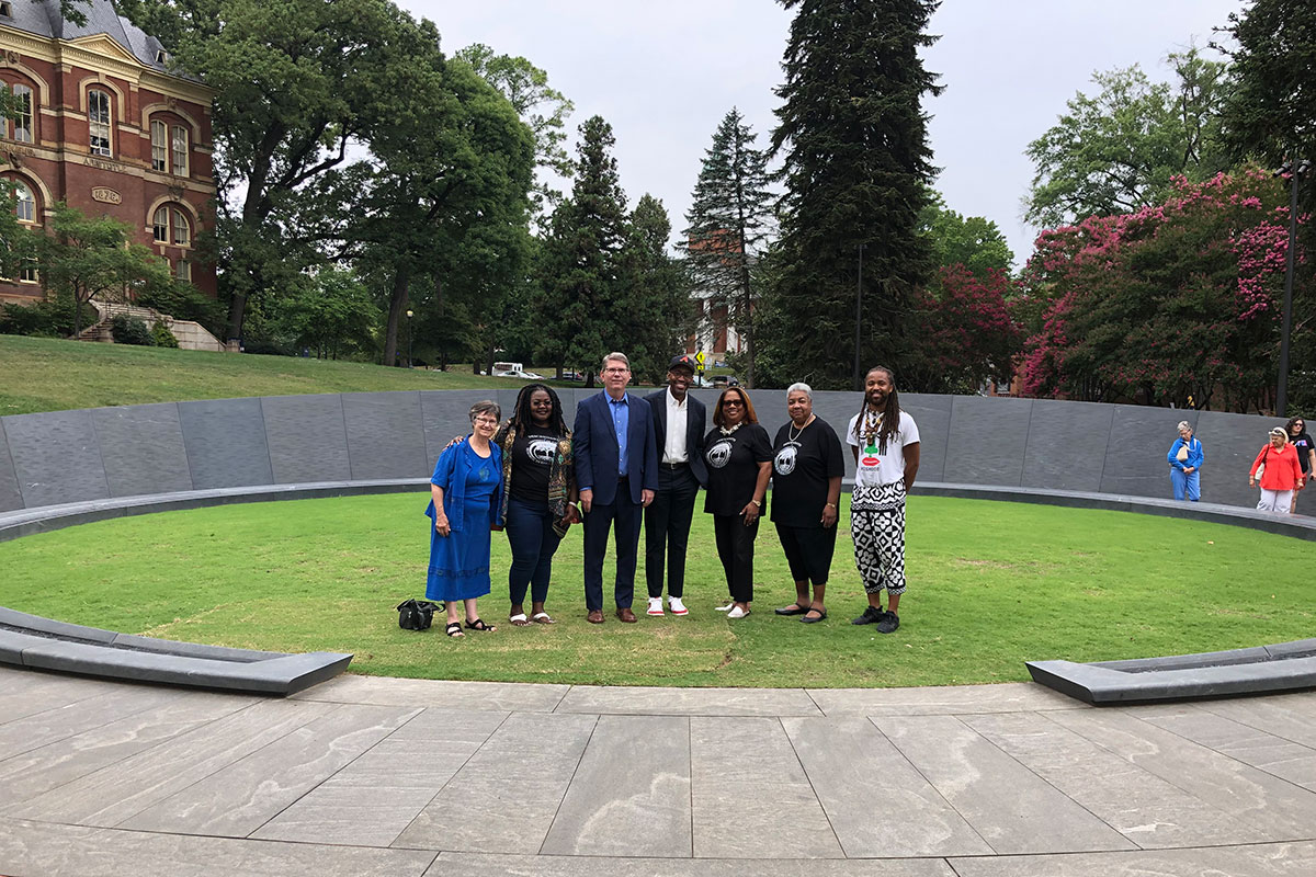 Oxford College Dean Douglas A. Hicks and professor Gregory Ellison II (third and fourth from left) met with descendant-community leaders, school administrators and a visitor to the site during their trip to the University of Virginia's Memorial to Enslaved Laborers.