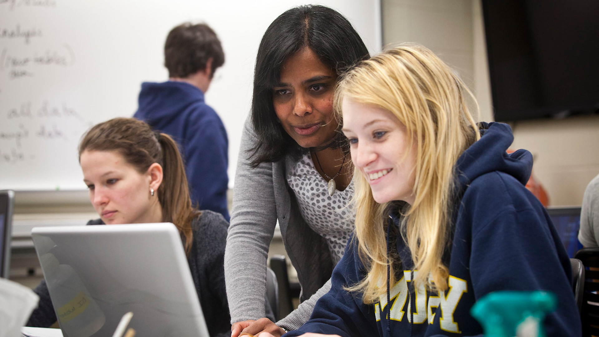 Nitya Jacob working with a student