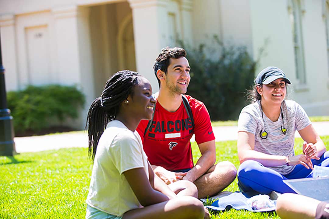 Students sit on the quad outside the Oxford Library.