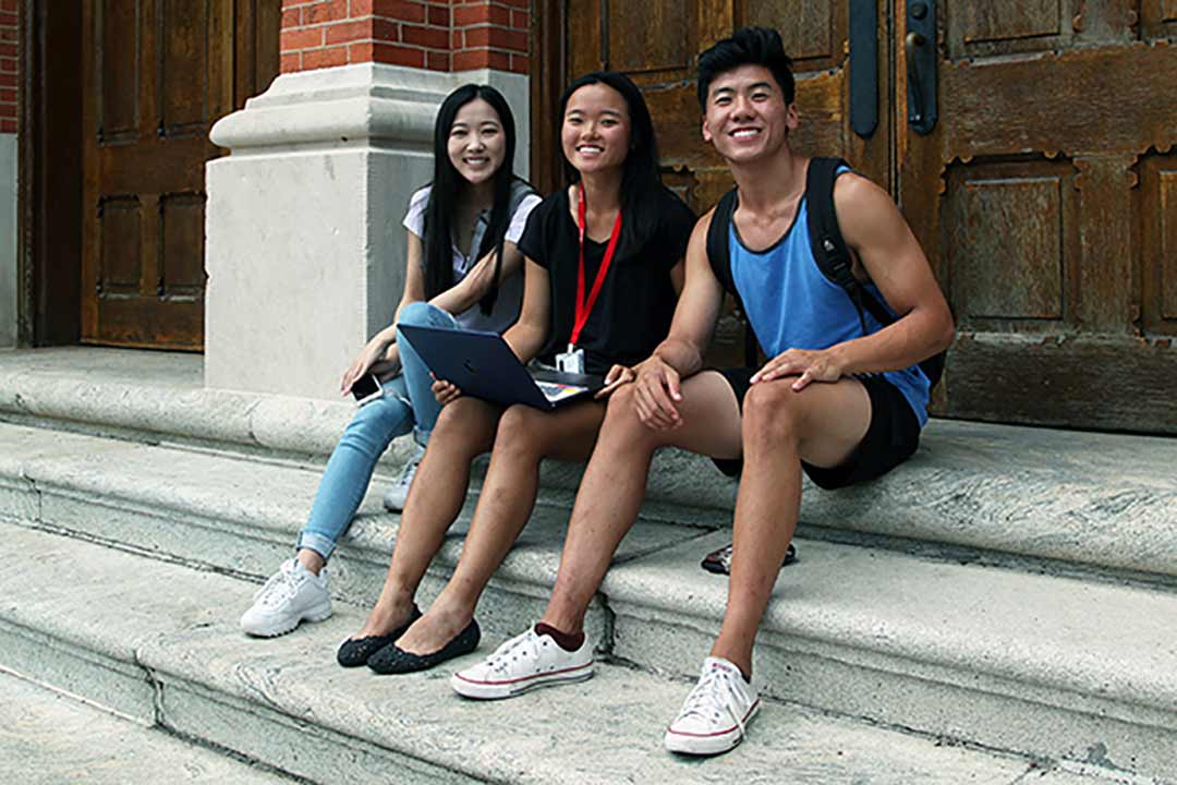 Students sit on the steps of Seney Hall.
