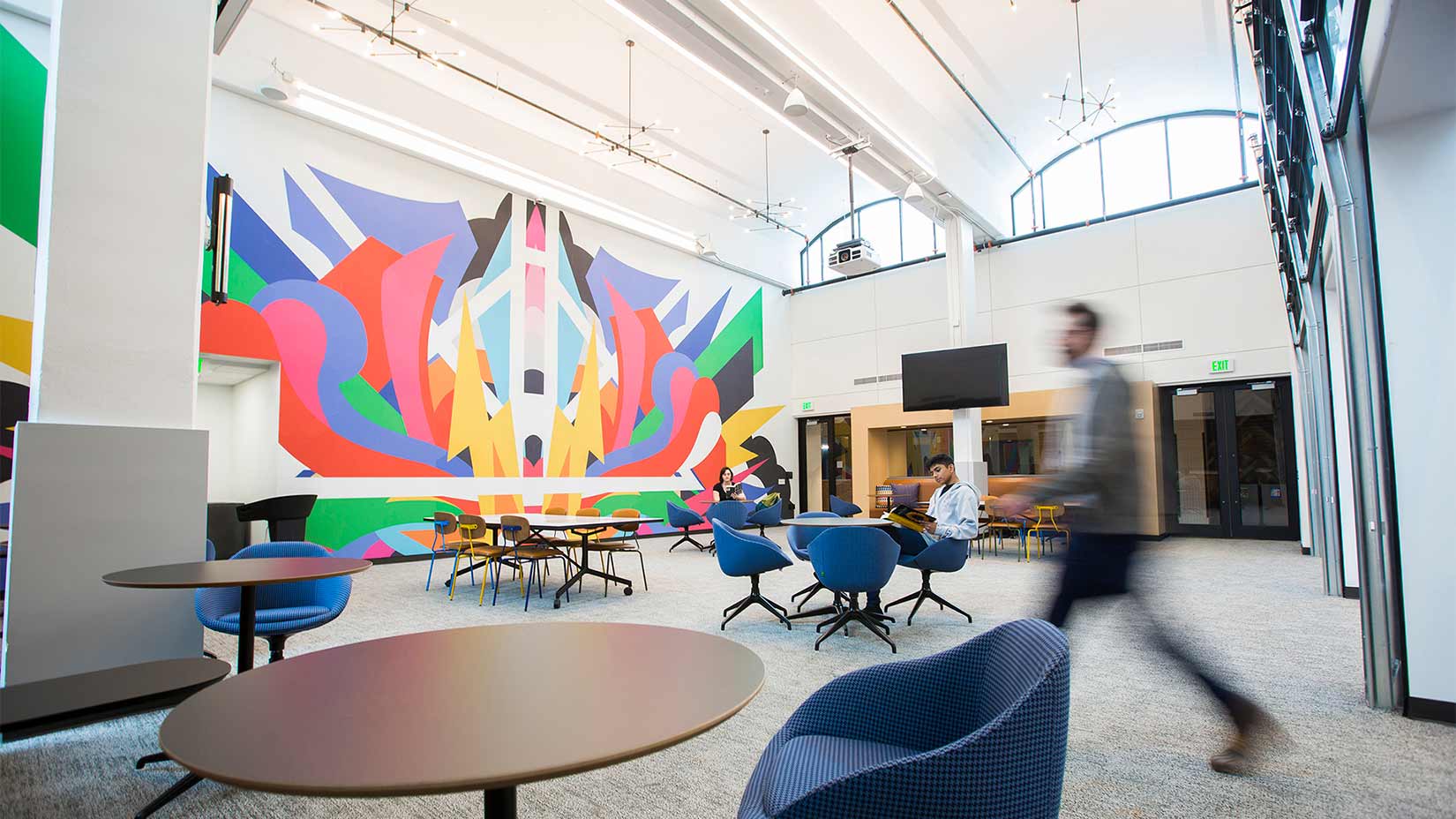 Students, faculty, and staff relax in the Mural Room of the Oxford Student Center.