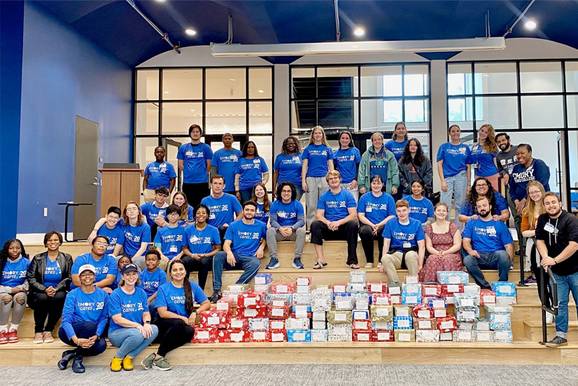 Volunteers pack donated toiletries into shoeboxes for children in foster care.